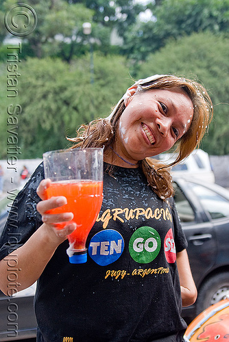 woman holding makeshift cup made with cut soda bottle, andean carnival, argentina, carnaval de la quebrada, drink, jujuy capital, noroeste argentino, san salvador de jujuy, woman