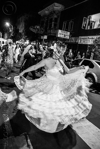 woman in white dress dancing in the street - dia de los muertos, dancing, day of the dead, dia de los muertos, face painting, facepaint, halloween, lace dress, night, sugar skull makeup, white dress, woman