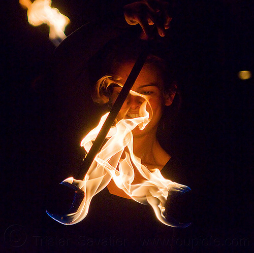 woman's face behind flames, ally, double staff, fire dancer, fire dancing, fire performer, fire spinning, fire staffs, night, staves, woman
