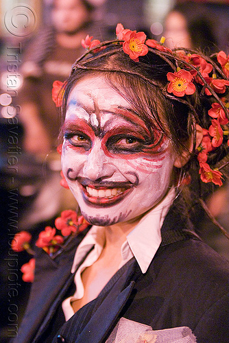woman with red and black face painting - día de los muertos - halloween (san francisco), day of the dead, dia de los muertos, face painting, facepaint, flower headdress, flower headwear, halloween, makeup, night, red flowers, woman