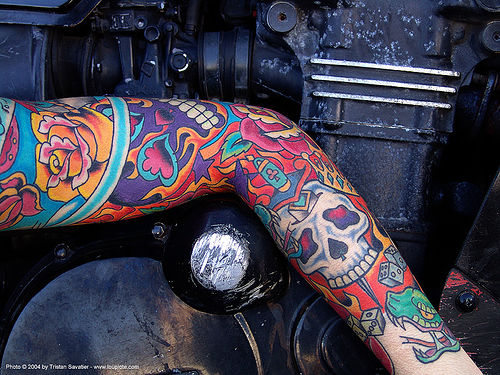 woman with skull and roses arm tattoo (san francisco), arm, colorful, motorcycle engine, rose tattoo, skin, skull tattoo, tattooed, tattoos, woman