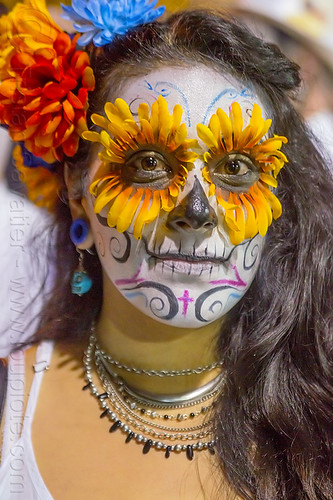 woman with sugar skull makeup and flower eyes, day of the dead, dia de los muertos, eyes, face painting, facepaint, flower headdress, flowers, halloween, necklaces, night, orange color, sugar skull makeup, woman