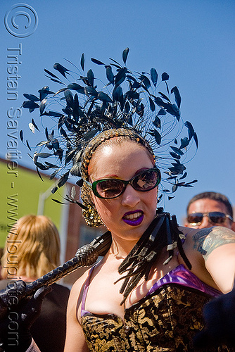 woman with whip - dore alley fair (san francisco), feather hat, feathers, leather whip, woman