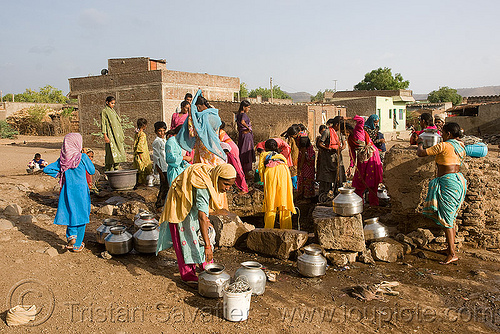 women around village water well - ajanta (india), ajanta, communal water well, crowd, drought, metal jars, pulling water, villagers, water jars, women
