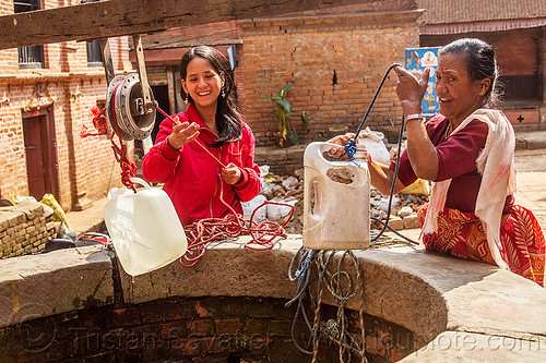 women pulling water jerrycans from water well (nepal), bhaktapur, plastic jerrycans, pulley, pulling water, ropes, water well, women