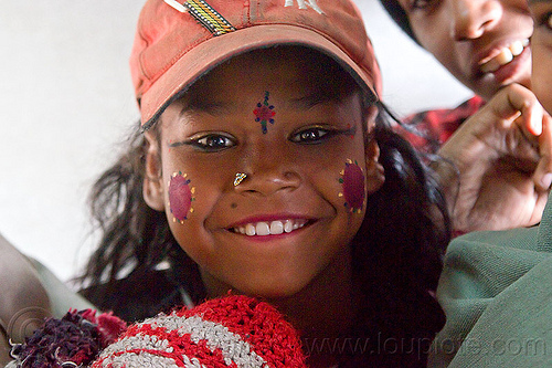 young indian girl - pierced nostril, cap, circus performer, contortionist, face paint, girl, hat, itinerant circus, makeup, nose piercing, nostril piercing, shiny eyes, tilak, tilaka