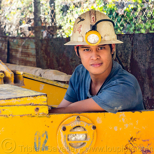 young miner in minecart - balatoc mines (philippines), balatoc mines, gold mine, head light, mancart, men, mine railway, mine train, mine trolley, mine worker, miner, safety helmet, workers