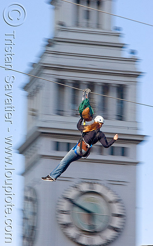 zip-line over san francisco, adventure, blue sky, cable line, cables, campanil, climbing helmet, clock tower, embarcadero tower, ferry building, hanging, mountaineering, moving fast, speed, steel cable, trolley, tyrolienne, urban, woman, zip line, zip wire
