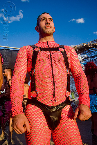 burning man - man wearing pink fishnet and leather, attire, burning man outfit, costume, fishnet bodysuit, leather underwear, pink, rings, straps