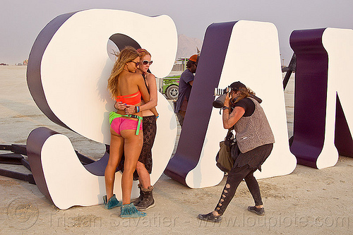 burning man - models in photoshoot at insanity, art installation, embrace, embracing, hugging, insanity, letters, photo shoot, photographer, shooting, women