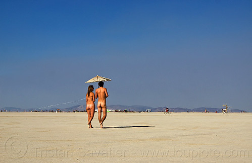 burning man - naked couple with japanese umbrella walking on the playa, japanese umbrella, man, nude, walking, woman