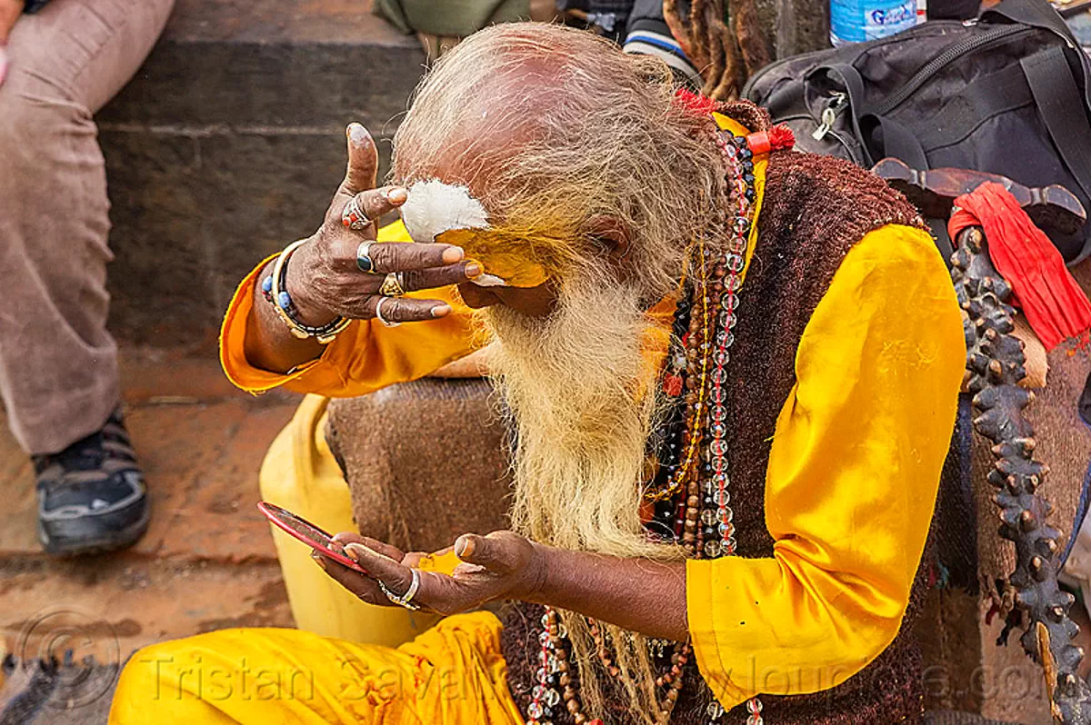 baba making tilaka mark on forehead (nepal), baba, beads, beard, bhagwa, bracelets, finger rings, hindu, hinduism, kathmandu, maha shivaratri, man, necklaces, pashupatinath, sadhu, talak, tilak, tilaka