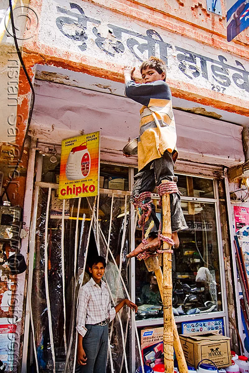 boy begging on stilts - jaipur (india), beggar, begging, boy, child, india, jaipur, pan handling, stilts, stiltwalker, stiltwalking, street kid