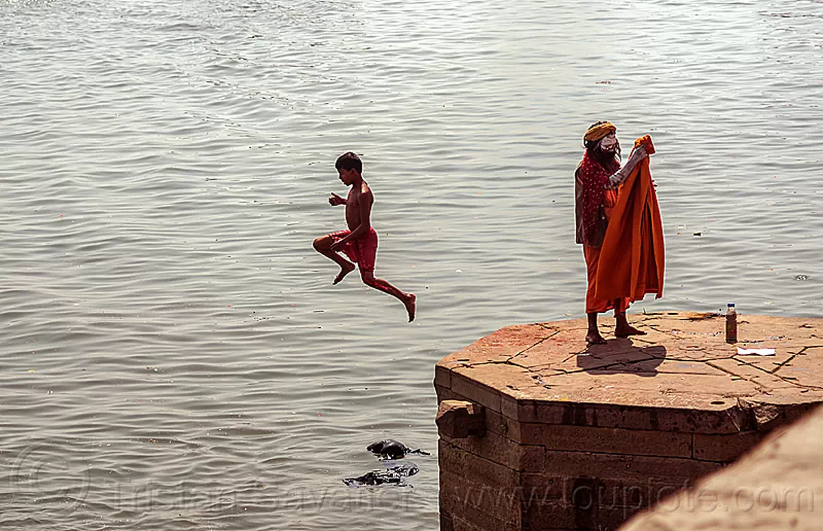 boy jumping from a ghat into the ganges river (varanasi), baba, boy, ganga, ganges river, ghats, hindu, hinduism, jump, men, river bank, sadhu, varanasi