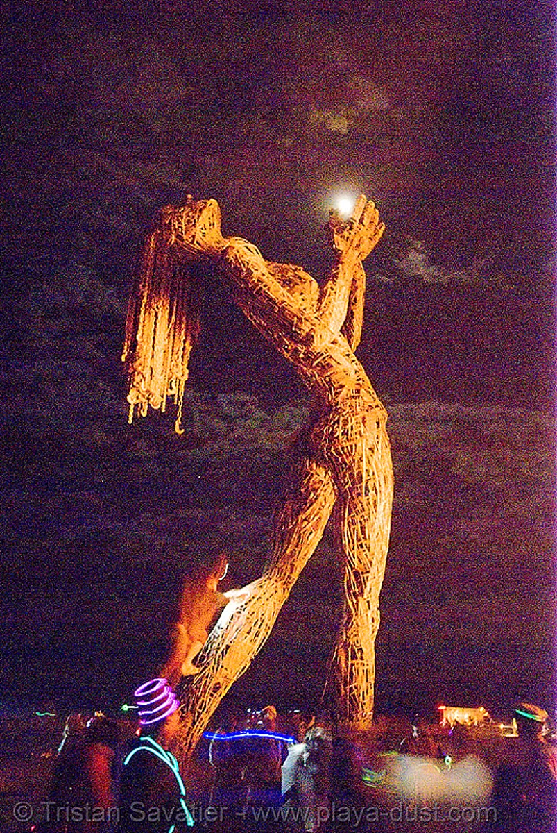 burning man - crude awakening, art installation, back light, burning man at night, full moon, sculpture