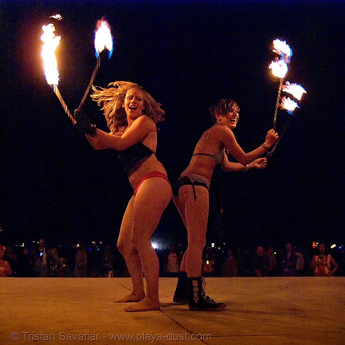 burning man - louise and gina, from ireland, spinning fire on the shiva vista stage, burning man at night, fire poi, shiva vista stage