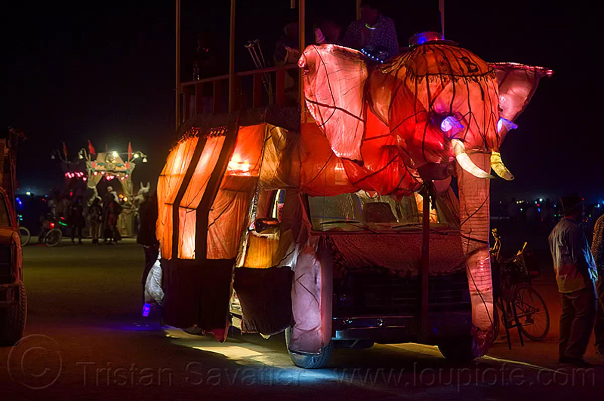 burning man - pink elephant art car, art car, beau le'phant, burning man art cars, burning man at night, glowing, mutant vehicles, pink elephant
