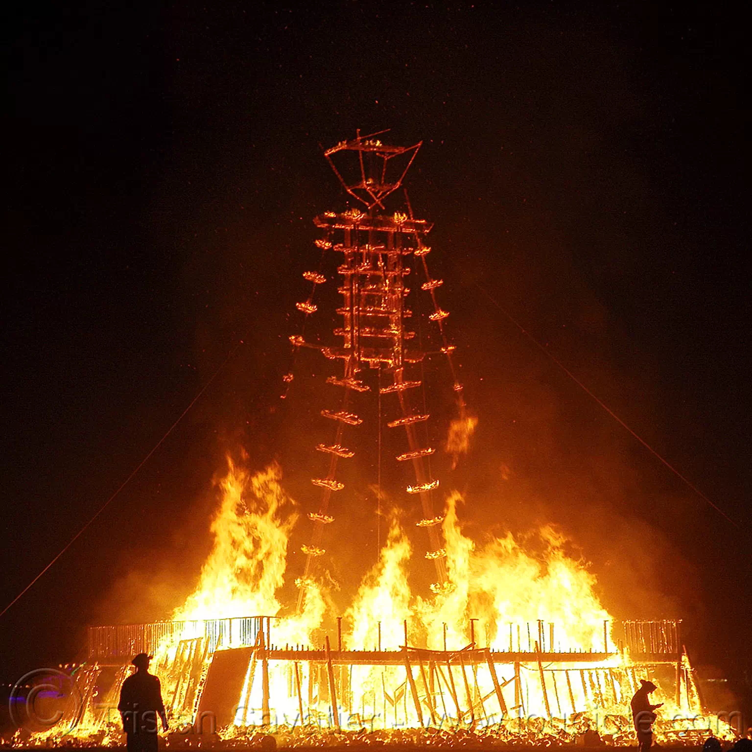 the burnt frame of the man is still standing - burning man 2015, burning man, chared, embers, fire, frame, night of the burn, silhouettes, the man