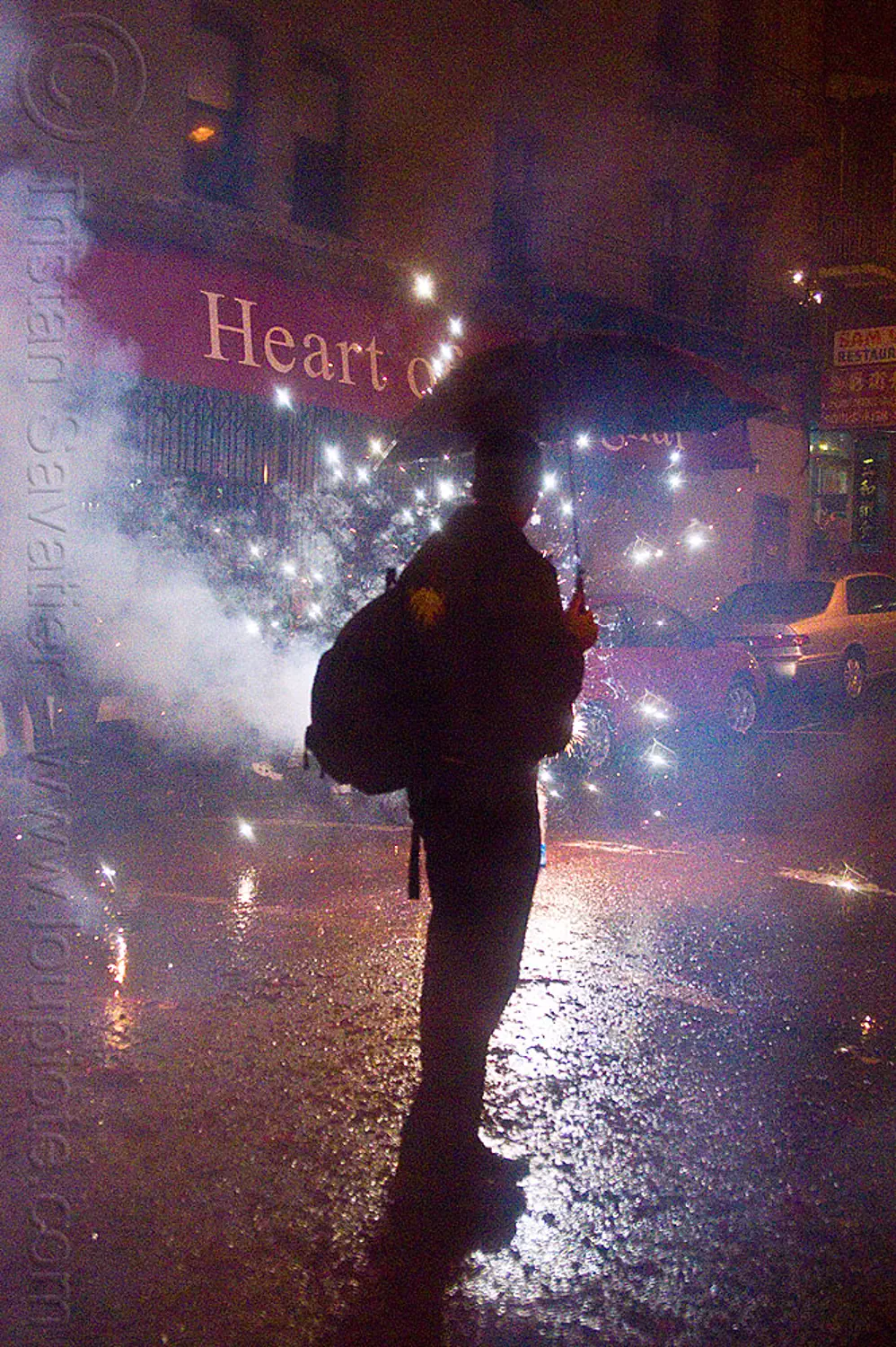 chinese new year in chinatown (san francisco), backlight, backpack, chinatown bang, chinese new year, firecrackers, grant st, heart of shanghai, lunar new year, man, night, pyrotechnics, silhouette, smoke, sparks, umbrella