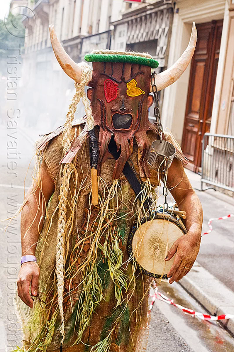 choukaj at the carnaval tropical de paris, caribbean, carnaval tropical, chain, choukaj, costumes, creole, créole, drum, guadeloupe, indigenous culture, man, mask, masked, parade, paris, traditional, tribal, west indies