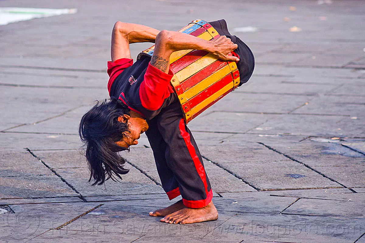 contortionist in barrel - street artist (jakarta), contortionist, eid ul-fitr, fatahillah square, indonesia, jakarta, man, street performer, taman fatahillah