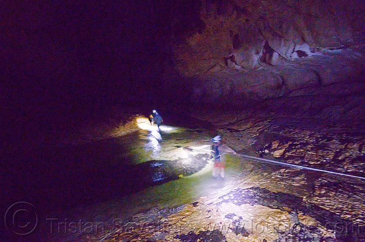 crossing underground river - caving in mulu (borneo), borneo, cavers, caving, clearwater cave system, clearwater connection, clearwater river, fording, gunung mulu national park, malaysia, natural cave, river cave, river crossing, rope, spelunkers, spelunking, underground river, wading