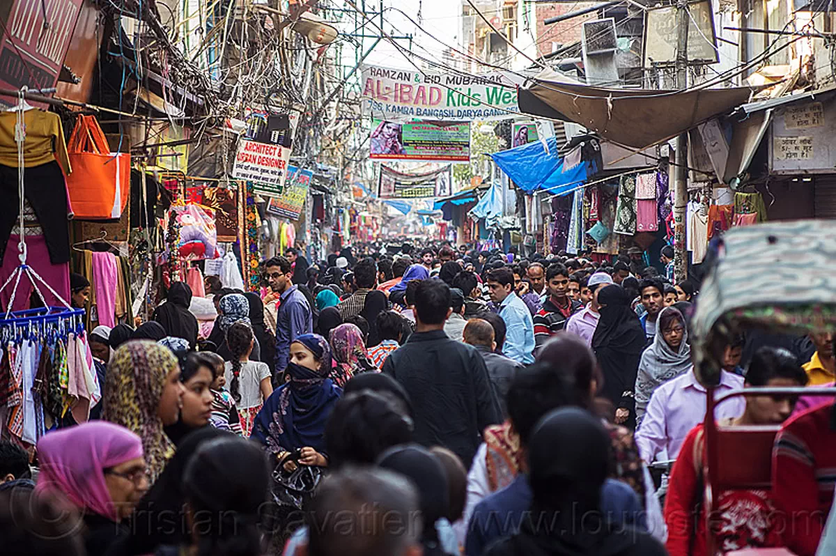 crowd in busy market street in muslim neighborhood of old delhi, india