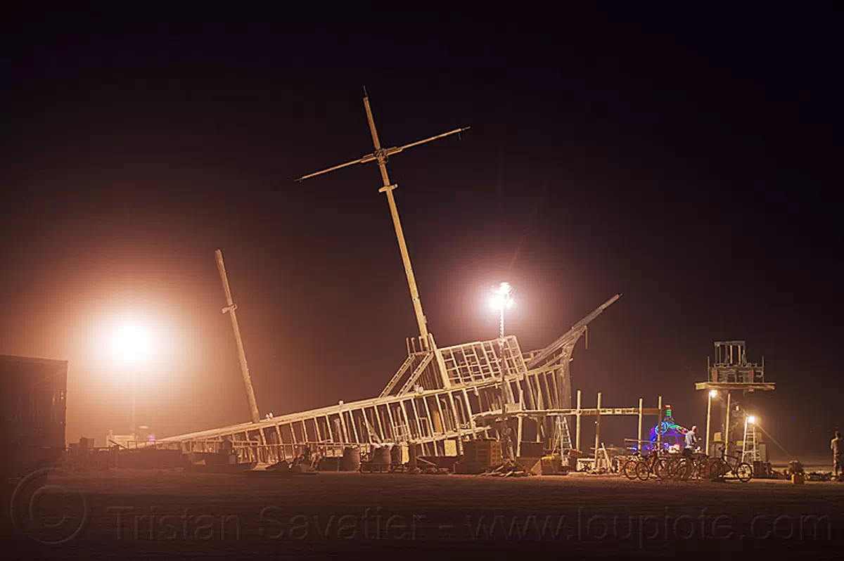 dismantling the shipwreck - burning man 2012, art installation, burning man, dismantling, mast, night, pier 2, ship, shipwreck, wood frame, wooden frame