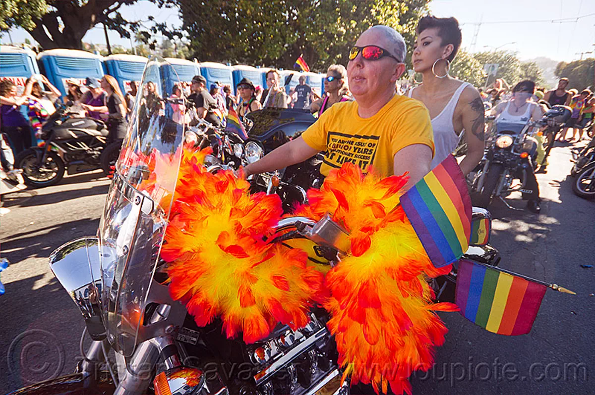 dykes on bikes - honda valkyrie, 1500cc, bald, dykes on bikes, feather boa, gay pride festival, honda valkyrie, motorcycle, orange feathers, rainbow flags, shaved head, women