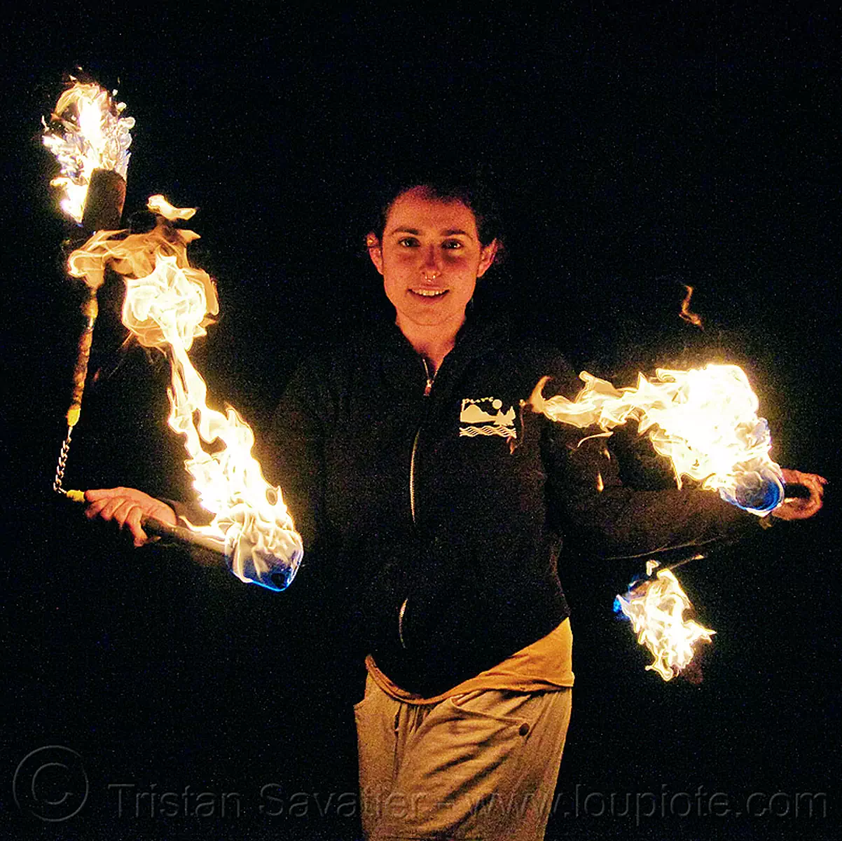 fire performer - fire nunchaku, fire dancer, fire dancing, fire nunchaku, fire performer, fire spinning, night, nose piercing, sarah, septum piercing, woman