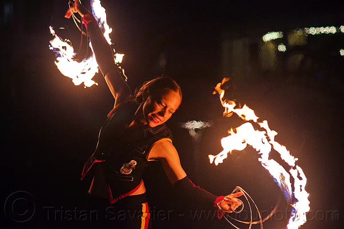 fire performer with fire fans, fire dancing expo, san francisco