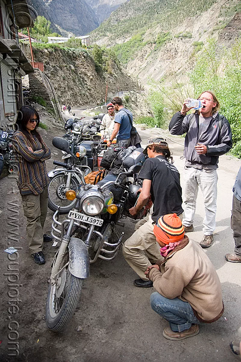 fixing the bikes - motorcycle mechanic shop - keylong - manali to leh road (india), christoph, grace liew, india, mechanic, motorcycle touring, road, royal enfield bullet, woman