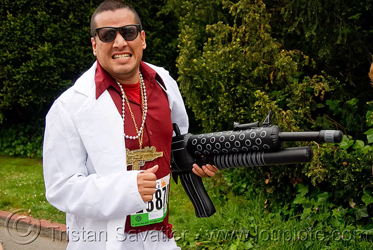 gangster with inflatable gun, automatic weapon, bay to breakers, costume, footrace, gangster, hand gun, hitman, inflatable gun, machine gun, mafia, mafioso, man, runner, street party, suit, sunglasses, toy gun, white