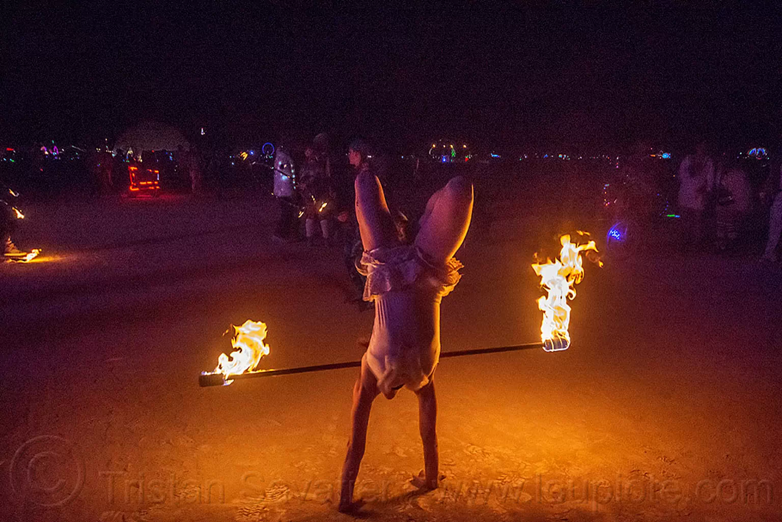 handstand with fire staff, burning man 2015