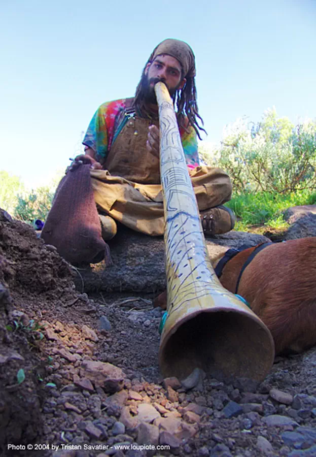 hippie guy playing didgeridoo, rainbow gathering 2004