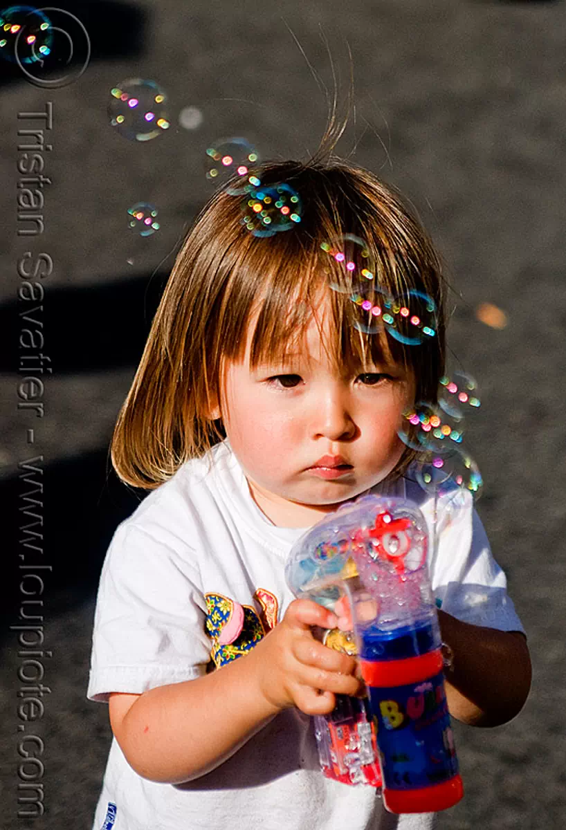 kid playing with bubble gun