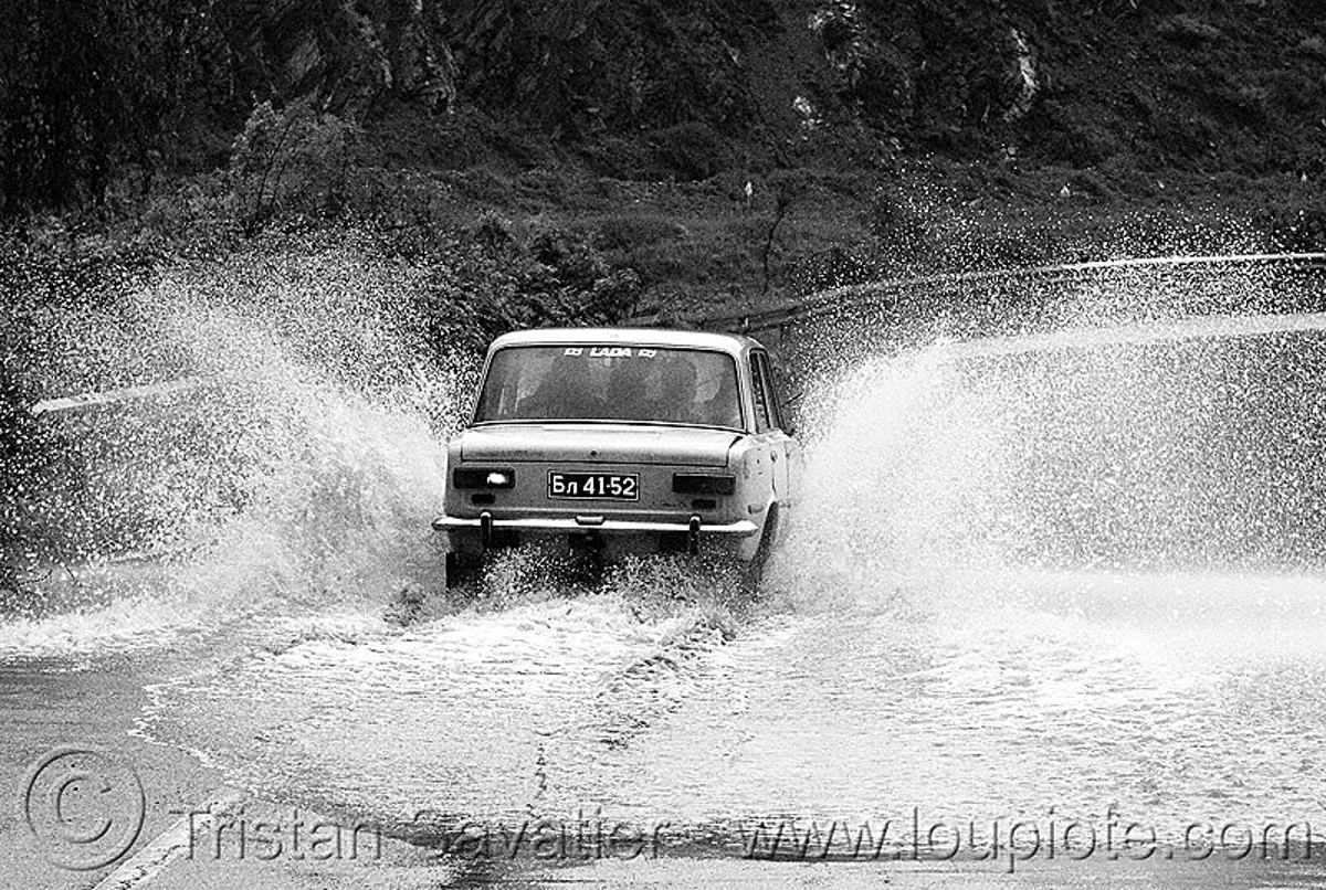 lada, car splashing water on road, bulgaria