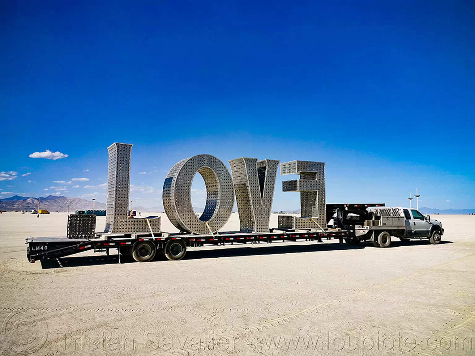LOVE sculpture - giant letters - burning man 2019, big words, burning man, large words, letters, love, metal sculpture, trailer, truck, word