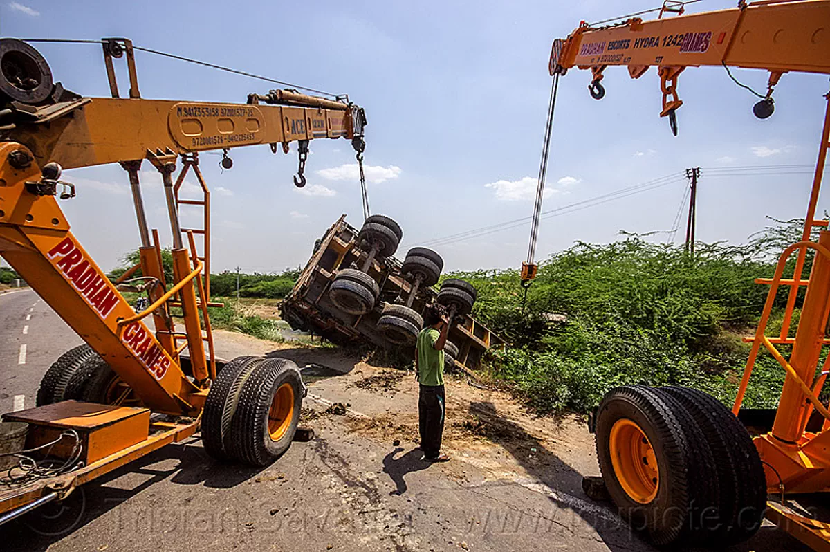 mobile cranes lift overturned semi truck, india