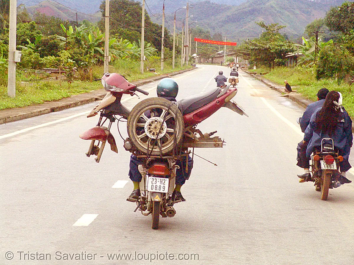 motorbike carrying another motorbike - vietnam, cargo, freight, loaded, motorcycles, rider, riding, road, underbone motorcycle, vietnam