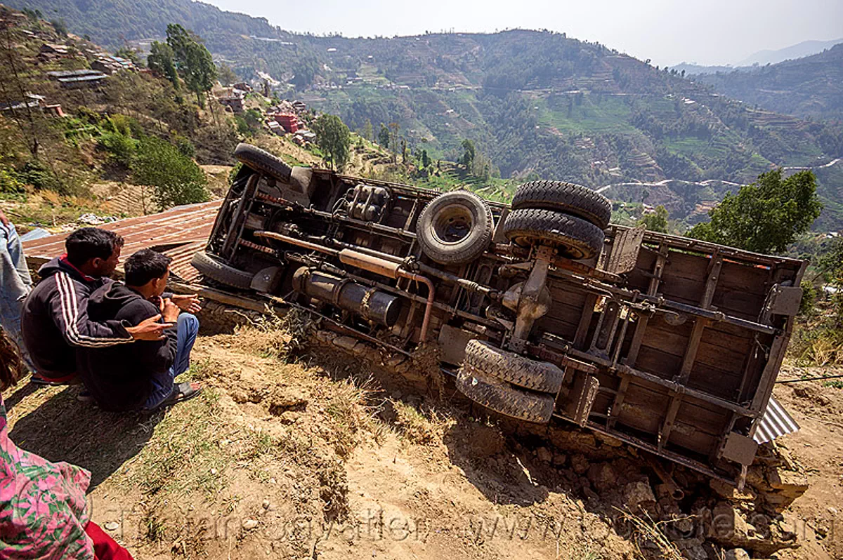 overturned truck in ditch off mountain road, nepal, traffic accident