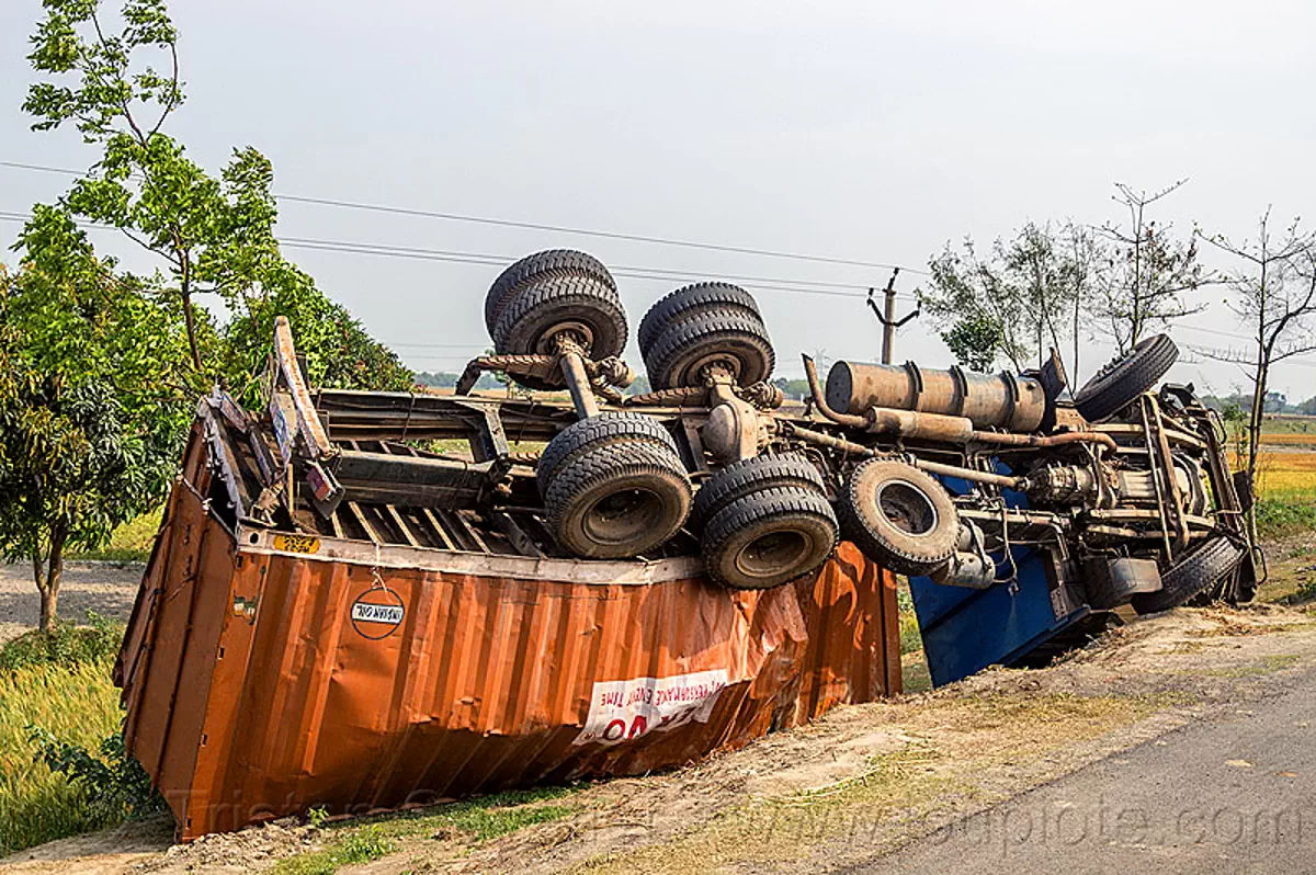 overturned truck with twisted frame, india