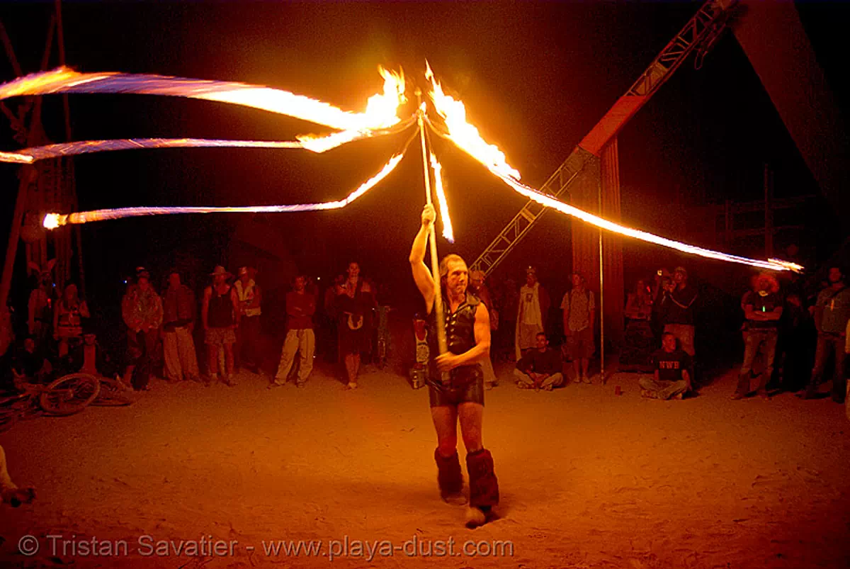 performer spinning fire ropes, burning man 2007