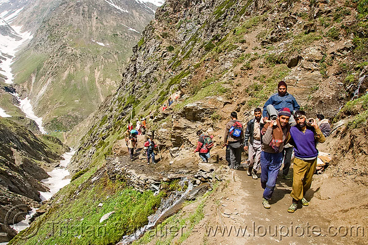 pilgrim on dandi / doli (chair carried by 4 porters) - pilgrims on trail - amarnath yatra (pilgrimage) - kashmir, amarnath yatra, bearers, dandi, doli, hiking, hindu pilgrimage, india, kashmir, men, mountain trail, mountains, pilgrims, porters, trekking, wallahs
