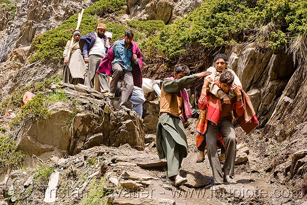 porters carrying exhausted woman on trail - amarnath yatra (pilgrimage) - kashmir, amarnath yatra, hiking, hindu pilgrimage, india, kashmir, men, mountain trail, mountains, pilgrims, porters, trekking, wallahs, woman