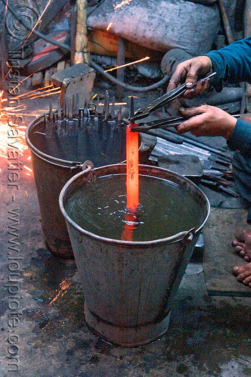 quench hardening in blacksmith workshop (delhi), blacksmith, delhi, india, ironwork, metal bucket, metalwork, metalworking, quench hardening, red hot, wood files, workshop