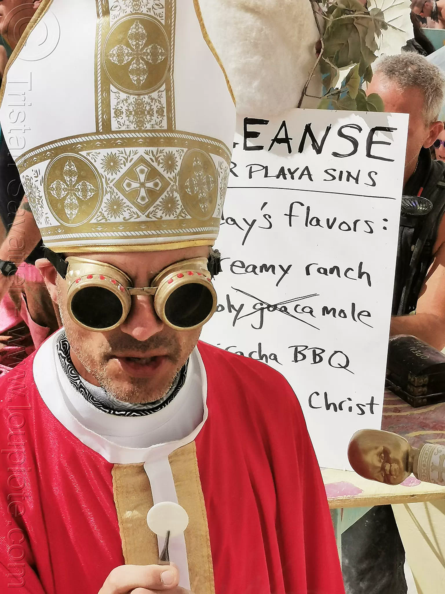 rory giving communion at center camp - burning man 2019, burning man, communion, goggles, headdress, priest, waffle