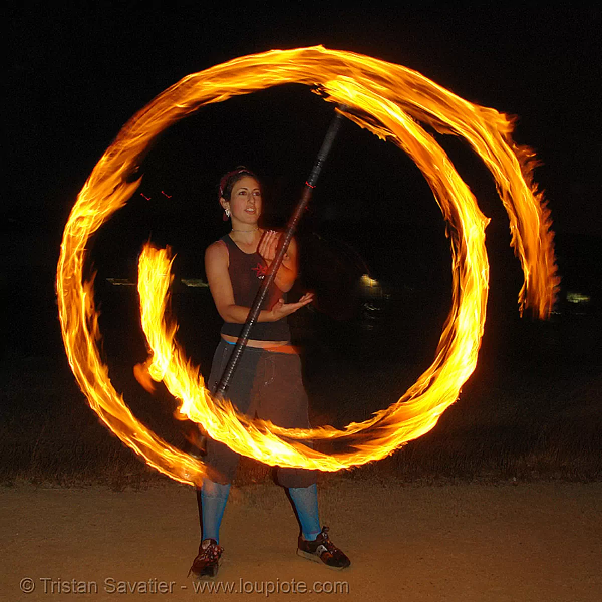 roxy spinning a fire staff