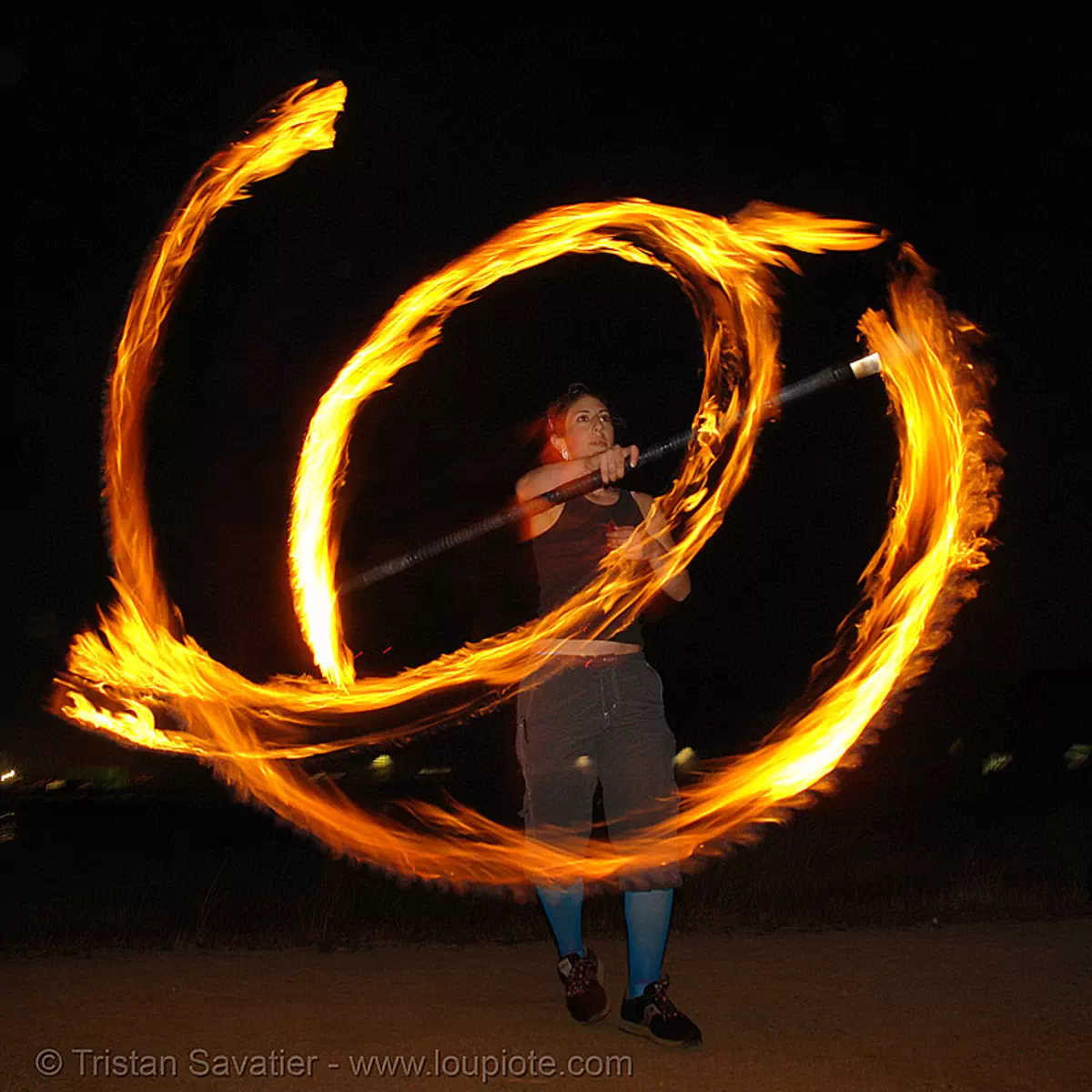 roxy spinning a fire staff