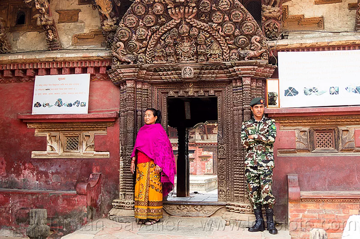 royal palace gate guarded by nepali soldier - bhaktapur durbar square (nepal), battledress, bhaktapur, durbar square, gate, guard, hinduism, intricate, man, military fatigues, nepalese army, soldier, uniform, woman, wood carving, wooden